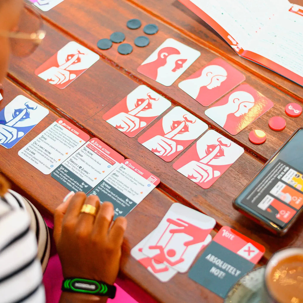 Thicker Than Blood card game cards and tokens setup on a wooden table